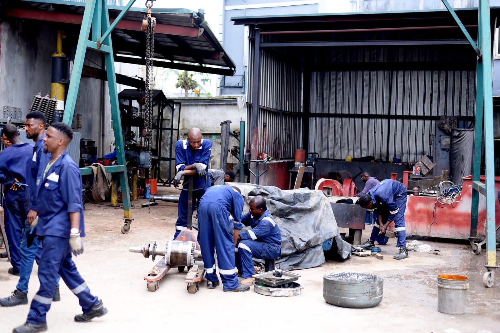 Crew servicing rotating equipment on the shop floor