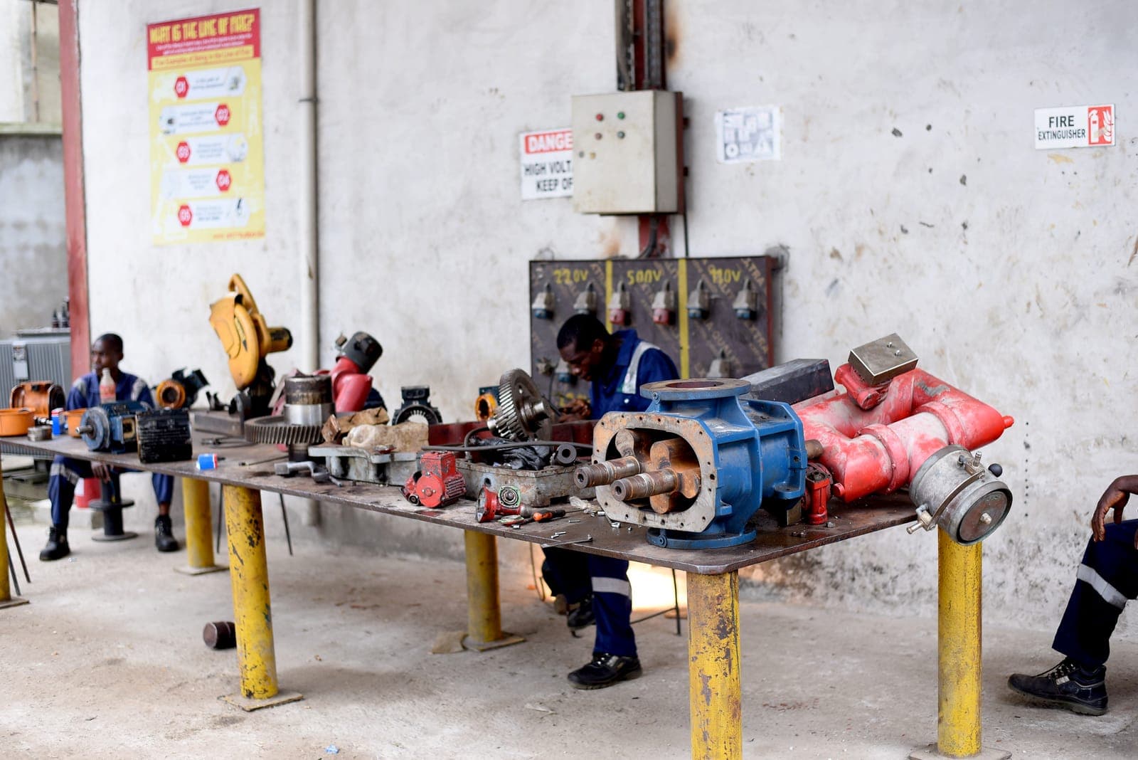 Dismantled components laid out on the workshop benches