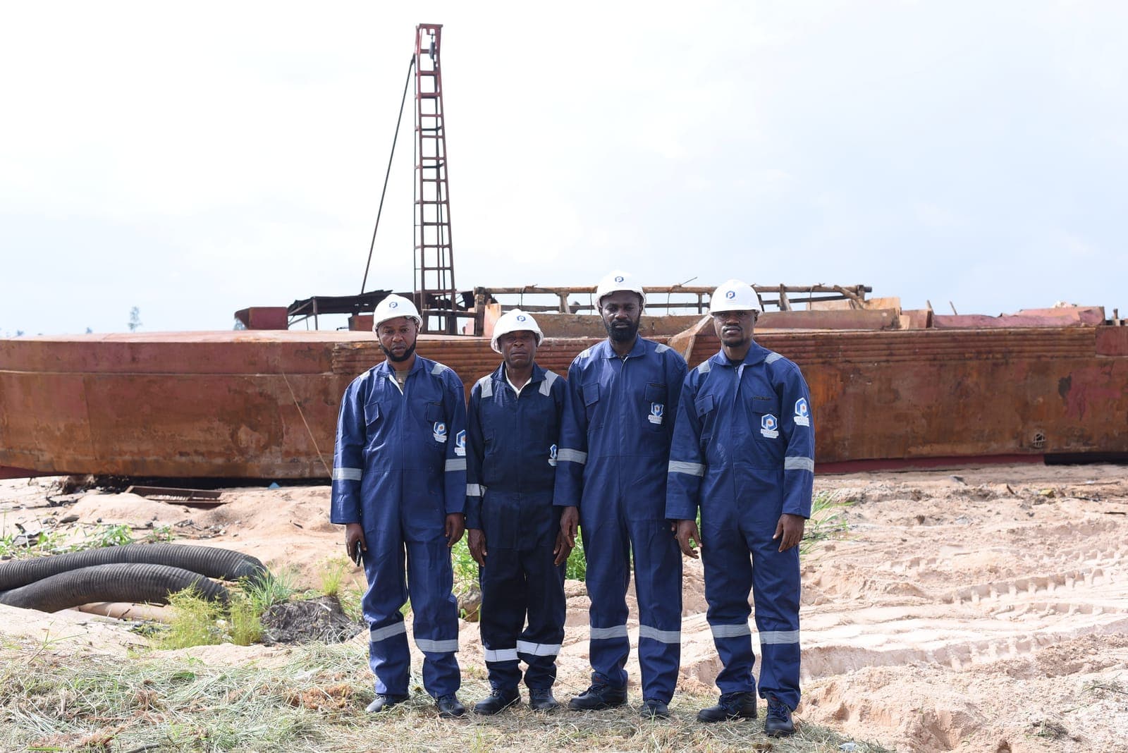 Crew alongside a barge at the waterfront
