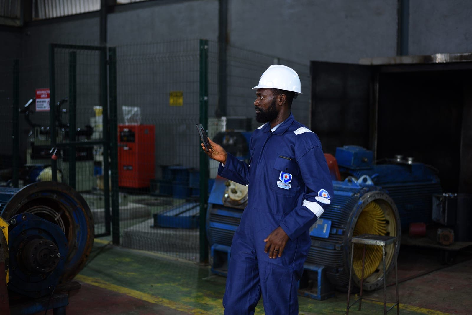 Supervisor inspecting rotating equipment in the workshop
