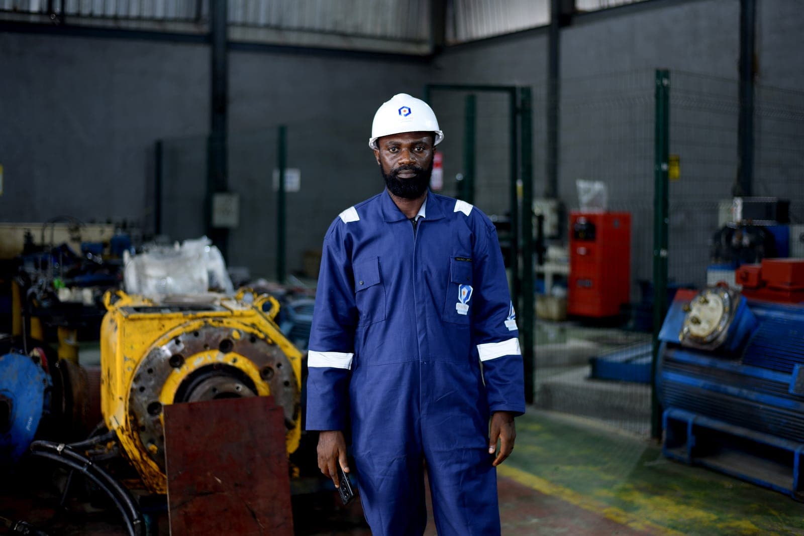 Technician beside a motor under maintenance